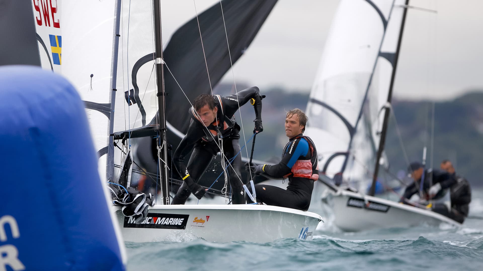 Swedish RS500 crew hiking upwind past a mark in grey conditions